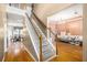 Inviting foyer with hardwood floors, staircase, and views into the dining and living areas at 485 Greyhawk Way, Fairburn, GA 30213