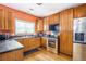 Well-equipped kitchen with stainless steel appliances and wood cabinetry at 485 Greyhawk Way, Fairburn, GA 30213