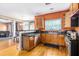 Well-equipped kitchen with stainless steel appliances and wood cabinetry that adjoins main living area at 485 Greyhawk Way, Fairburn, GA 30213