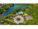 An aerial view of community amenities includes a pool, clubhouse, tennis court and lake at 5625 Jamerson Dr, Atlanta, GA 30349
