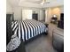 Main bedroom with a ceiling fan, a bed, an easy chair, and a dresser at 5625 Jamerson Dr, Atlanta, GA 30349