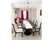 Elegant dining room featuring a chandelier, large table with seating for six, and neutral decor at 5625 Jamerson Dr, Atlanta, GA 30349