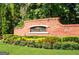 Brick sign for Stonewall Manor community featuring colorful landscaping in front at 5625 Jamerson Dr, Atlanta, GA 30349