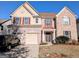 Inviting two-story home featuring a brick facade, attached two-car garage, and well-maintained landscaping at 5625 Jamerson Dr, Atlanta, GA 30349