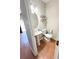 Functional half bathroom with pedestal sink, toilet, and open shelving for storage convenience at 5625 Jamerson Dr, Atlanta, GA 30349