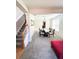 Spacious living room featuring a dining area, stairs, and neutral-colored walls, promoting an airy environment at 5625 Jamerson Dr, Atlanta, GA 30349