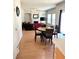 Open-concept living area with a dining table, corner sofa, fireplace, and backyard access at 5625 Jamerson Dr, Atlanta, GA 30349