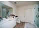 Modern bathroom featuring dual sinks, sleek white cabinetry, and a glass-enclosed shower for a contemporary aesthetic at 108 Park Pl # 108, Atlanta, GA 30030