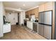 A well-lit kitchen featuring stainless steel appliances, wood-tone cabinets, and white countertops at 108 Park Pl # 108, Atlanta, GA 30030