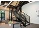 Modern staircase with a sleek design for easy access to upper floors, adjacent to a seating area at 108 Park Pl # 108, Atlanta, GA 30030