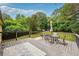 Wooden back deck with wooded views, dining table and plenty of room for entertaining at 2220 Williams Ln, Cumming, GA 30028