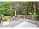 Wooden back deck with dining table and umbrella, overlooking the spacious backyard at 2220 Williams Ln, Cumming, GA 30028