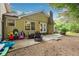 Charming back patio with string lights, stone fireplace and two comfortable chairs at 2220 Williams Ln, Cumming, GA 30028
