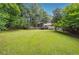 Expansive, verdant backyard with established trees, patio and a private fence at 2220 Williams Ln, Cumming, GA 30028