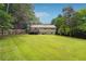 Large backyard with beautiful landscaping, a deck and a fence for privacy at 2220 Williams Ln, Cumming, GA 30028