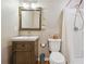 Bathroom featuring updated sink, wood cabinets, and shower at 2220 Williams Ln, Cumming, GA 30028