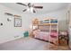 Bright bedroom with a bunk bed, neutral carpet, and natural light from the window at 2220 Williams Ln, Cumming, GA 30028
