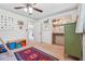 Bright bedroom with a ceiling fan, colorful decorations, and a closet with changing table at 2220 Williams Ln, Cumming, GA 30028