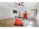 Bedroom featuring a ceiling fan, tv, and an adjacent bathroom entrance at 2220 Williams Ln, Cumming, GA 30028