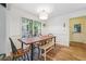 Bright dining area with wood-look flooring, large window, and a simple, modern light fixture at 2220 Williams Ln, Cumming, GA 30028