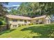 Traditional home with neat landscaping, an attached garage, and a sprawling green lawn at 2220 Williams Ln, Cumming, GA 30028