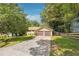 Ranch-style home with a long driveway and attached two-car garage; mature trees at 2220 Williams Ln, Cumming, GA 30028