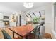 Bright kitchen with white cabinets, stainless steel appliances, and a rustic dining table open to the living room at 2220 Williams Ln, Cumming, GA 30028