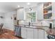 A bright kitchen showcases stainless steel appliances, white cabinets, and dark countertops at 2220 Williams Ln, Cumming, GA 30028