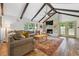 Spacious living room with vaulted ceilings, exposed beams, and a stone fireplace at 2220 Williams Ln, Cumming, GA 30028