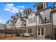 Townhome backyard with a patio, outdoor seating, and well-maintained fencing at 3450 Commander Cv, Suwanee, GA 30024