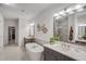 Bright bathroom showcasing a soaking tub, double vanity, and modern fixtures at 3450 Commander Cv, Suwanee, GA 30024