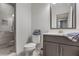 Well-lit bathroom featuring a walk-in shower with glass door, sleek vanity, and modern fixtures at 3450 Commander Cv, Suwanee, GA 30024
