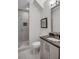 Modern bathroom features a glass-enclosed shower and vanity with dark countertop at 3450 Commander Cv, Suwanee, GA 30024