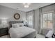 A cozy bedroom with a large window that provides plenty of natural light and a nice view at 3450 Commander Cv, Suwanee, GA 30024