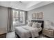 Cozy bedroom with a queen bed, neutral color scheme, and natural light at 3450 Commander Cv, Suwanee, GA 30024