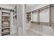 Walk-in closet featuring custom shelving and ample storage space for organization at 3450 Commander Cv, Suwanee, GA 30024