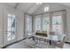 Informal dining room with bright natural light, hardwood floors, and view to outdoor scenery at 3450 Commander Cv, Suwanee, GA 30024