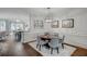 Bright dining room features a hardwood floor, light gray walls, and modern lighting at 3450 Commander Cv, Suwanee, GA 30024