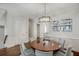 An eye-level view of a formal dining area showing wainscotting, light fixture, and hardwood floor at 3450 Commander Cv, Suwanee, GA 30024