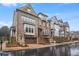 Lovely townhomes display stone and brick exteriors, individual garages, and manicured front yards at 3450 Commander Cv, Suwanee, GA 30024