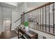 Stylish entryway with hardwood floors, iron railing, and a glimpse of the dining area at 3450 Commander Cv, Suwanee, GA 30024