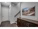Hallway with staircase and display cabinet leading to a community center artwork at 3450 Commander Cv, Suwanee, GA 30024