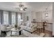 Bright living area with comfortable seating, natural light, and a view of the neighborhood at 3450 Commander Cv, Suwanee, GA 30024