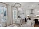 Sitting area features a large window, fireplace, and view into the kitchen at 3450 Commander Cv, Suwanee, GA 30024