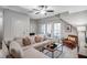 Comfortable living room features a sectional sofa, accent pillows, and a ceiling fan at 3450 Commander Cv, Suwanee, GA 30024