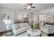 Open-concept living space with a comfortable sofa, elegant decor, and seamless dining area access at 3450 Commander Cv, Suwanee, GA 30024