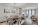 Open concept view of the dining area and living room with fireplace and hardwood floors at 3450 Commander Cv, Suwanee, GA 30024