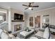 Inviting covered outdoor patio features a fireplace, TV, and comfortable seating area at 3450 Commander Cv, Suwanee, GA 30024
