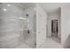 Luxurious walk-in shower with elegant tilework, glass enclosure and modern fixtures at 3450 Commander Cv, Suwanee, GA 30024