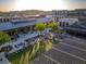 Aerial view of the community town center with shops, restaurants, crowds of people, and green spaces at 3450 Commander Cv, Suwanee, GA 30024